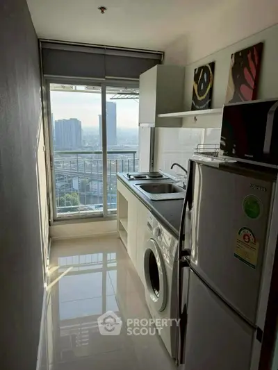 Modern kitchen with city view, featuring sleek appliances and ample natural light.