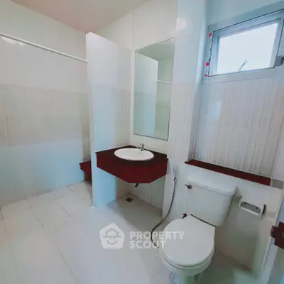 Spacious modern bathroom with sleek fixtures and natural light