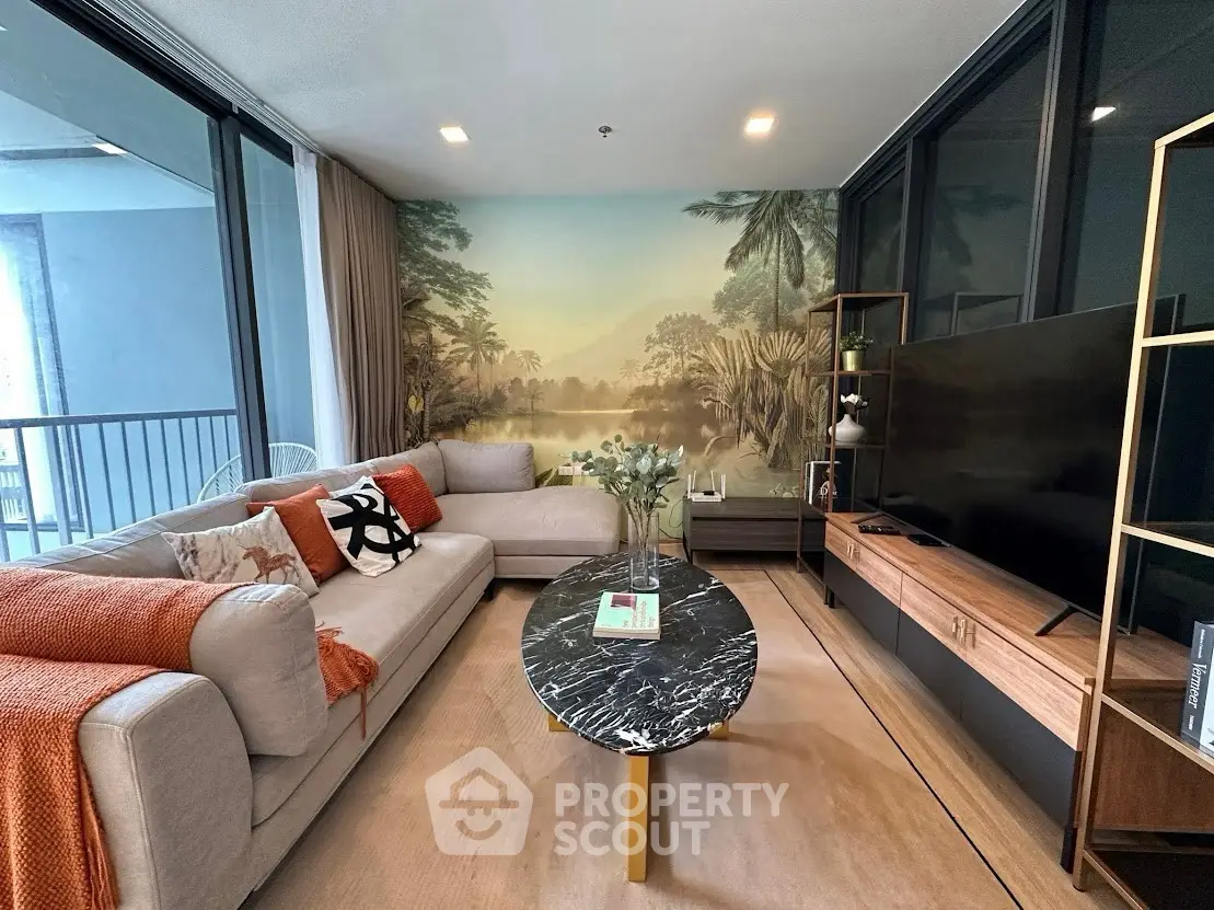 Stylish living room with modern decor and scenic wall mural, featuring a cozy sofa and sleek entertainment unit.