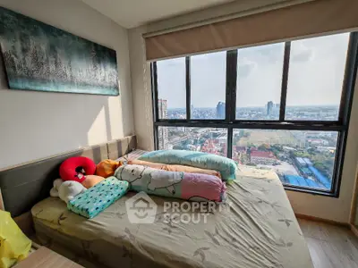 Cozy bedroom with large window offering stunning city view