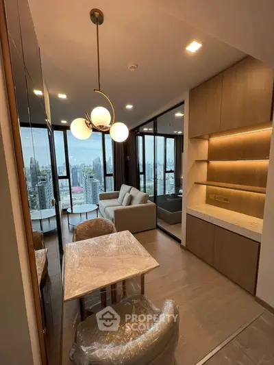 Modern living room with city view, stylish lighting, and open layout in a high-rise apartment.