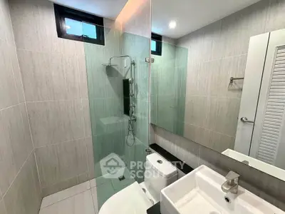 Modern bathroom with glass shower and sleek fixtures