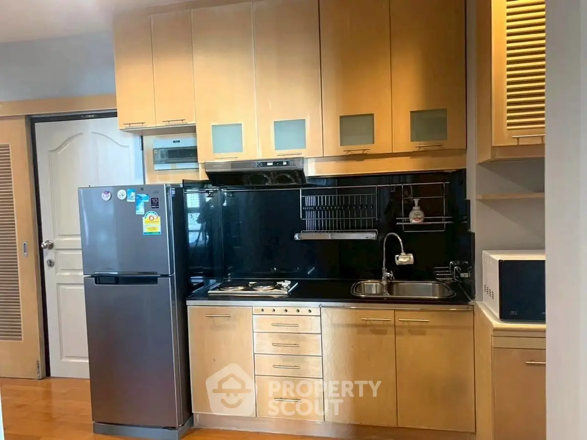 Modern kitchen with wooden cabinets and stainless steel appliances