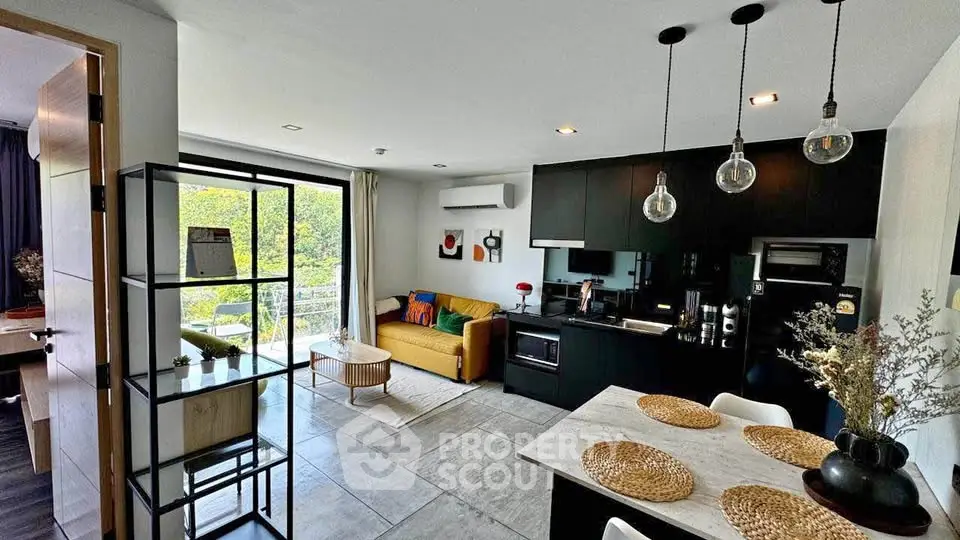 Modern open-plan living room and kitchen with stylish decor and natural light.