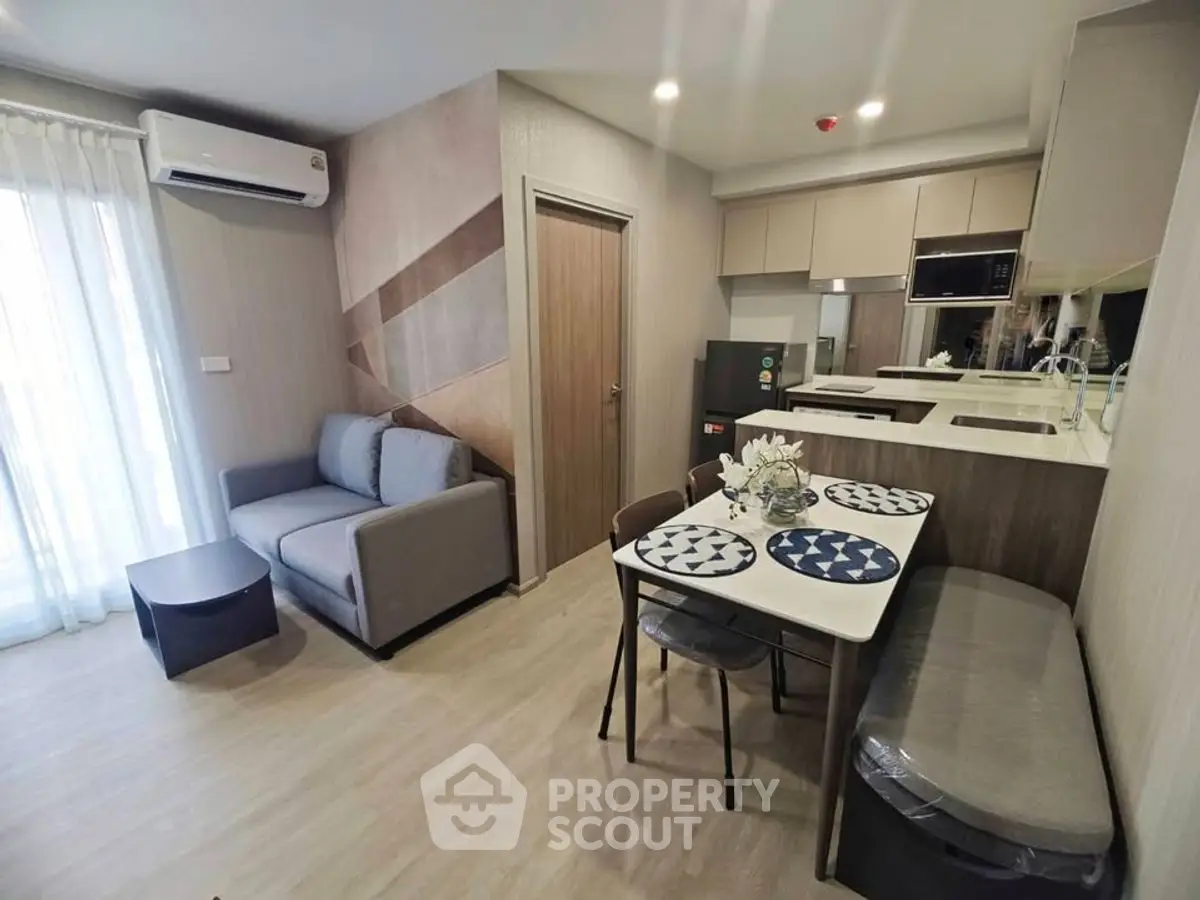 Modern open-plan living room with cozy sofa and stylish kitchen area