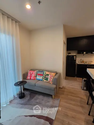 Cozy living room with modern decor and open kitchen layout, perfect for urban living.