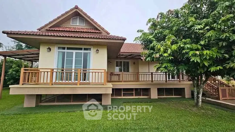 Charming single-story home with spacious wooden deck and lush green garden