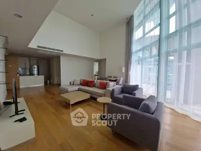 Spacious modern living room with high ceilings and large windows