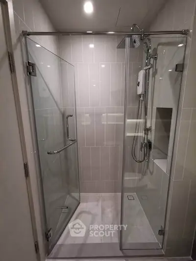 Modern bathroom with glass shower enclosure and sleek fixtures