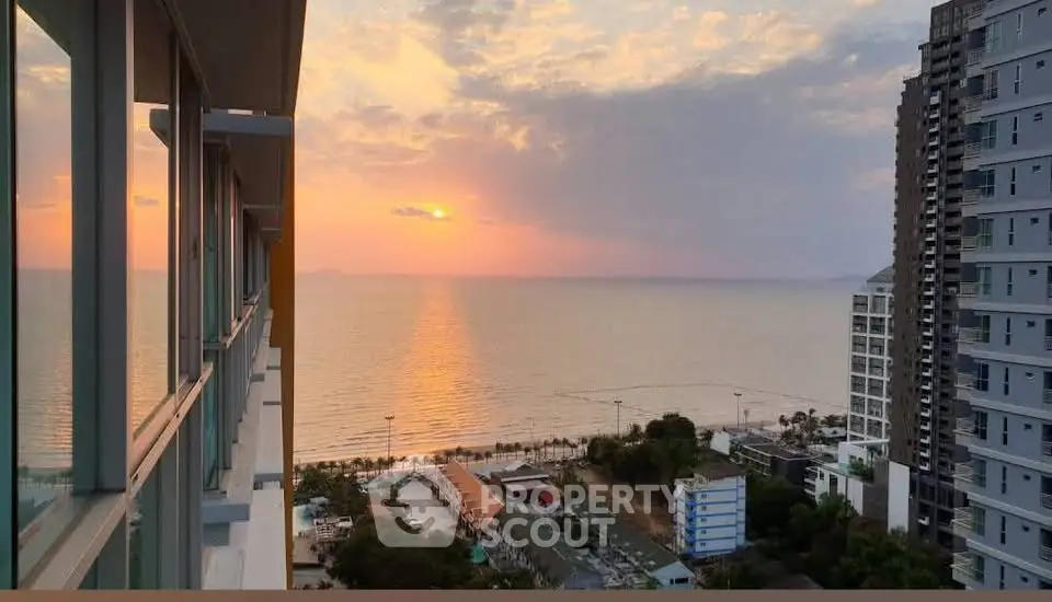 Stunning ocean view from high-rise balcony at sunset, perfect for luxury living.