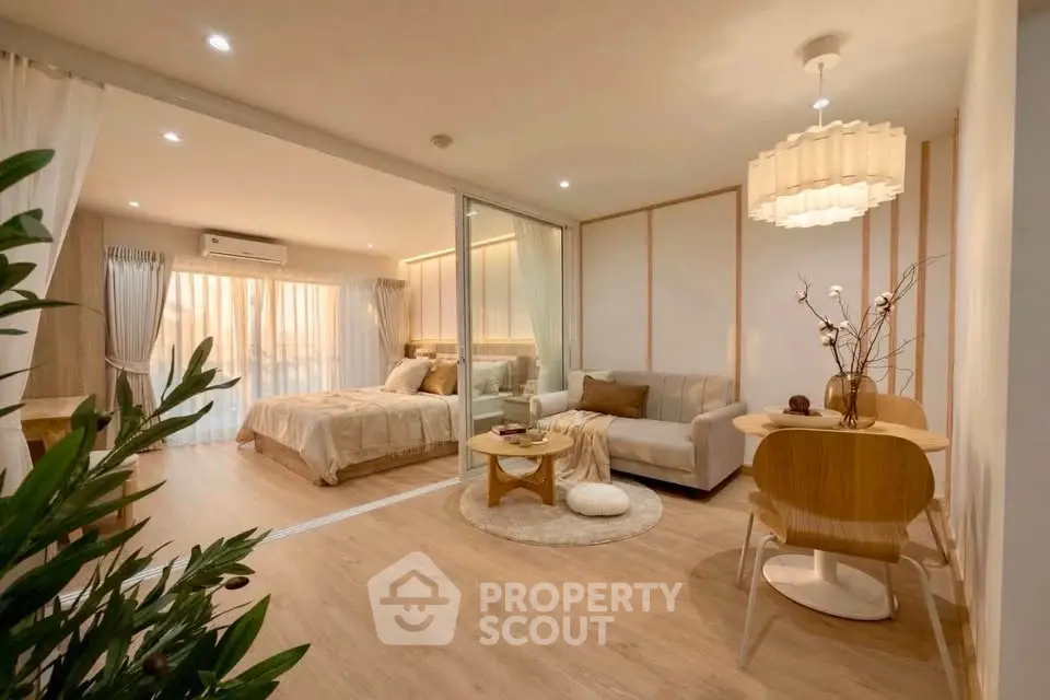Modern open-plan living room and bedroom with stylish decor and natural light.