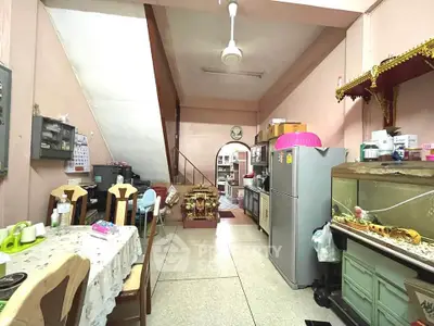 Cozy kitchen-dining area with eclectic decor and ample storage space