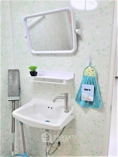 Charming bathroom with floral tiles and modern sink, perfect for a cozy home.