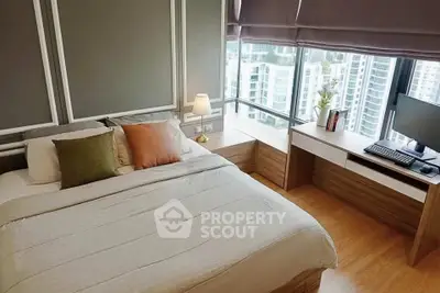 Modern bedroom with city view, featuring cozy bed and stylish workspace.