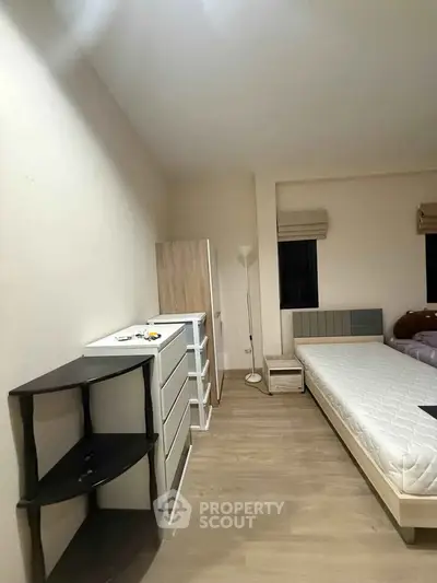 Spacious bedroom with minimalist furniture and natural light