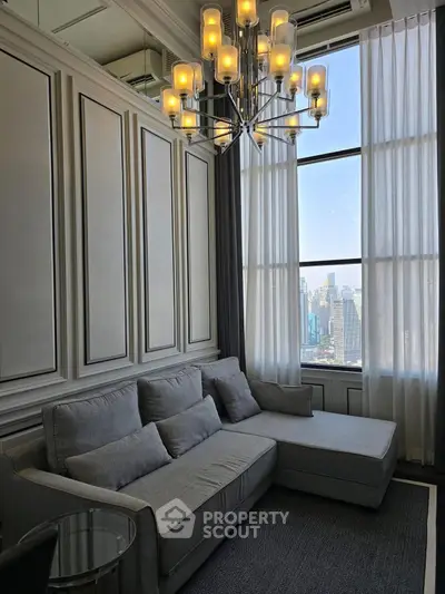 Luxurious living room with elegant chandelier and stunning city view
