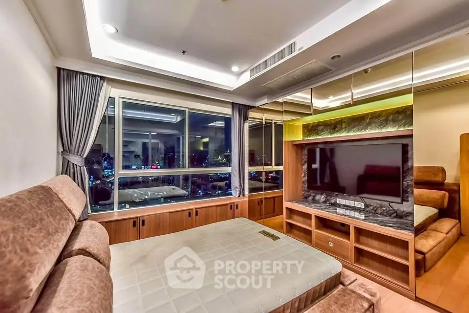 Luxurious bedroom with large window and modern furnishings, offering a stunning city view.