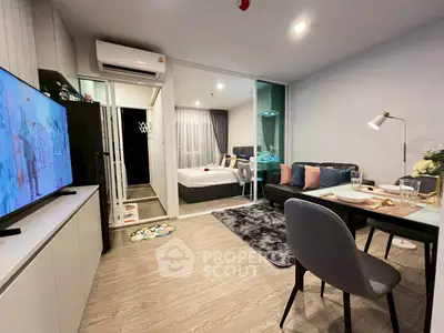 Modern open-plan living room with stylish decor and cozy bedroom view