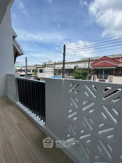 Charming balcony with decorative railing and city view, perfect for relaxation and enjoying the outdoors.
