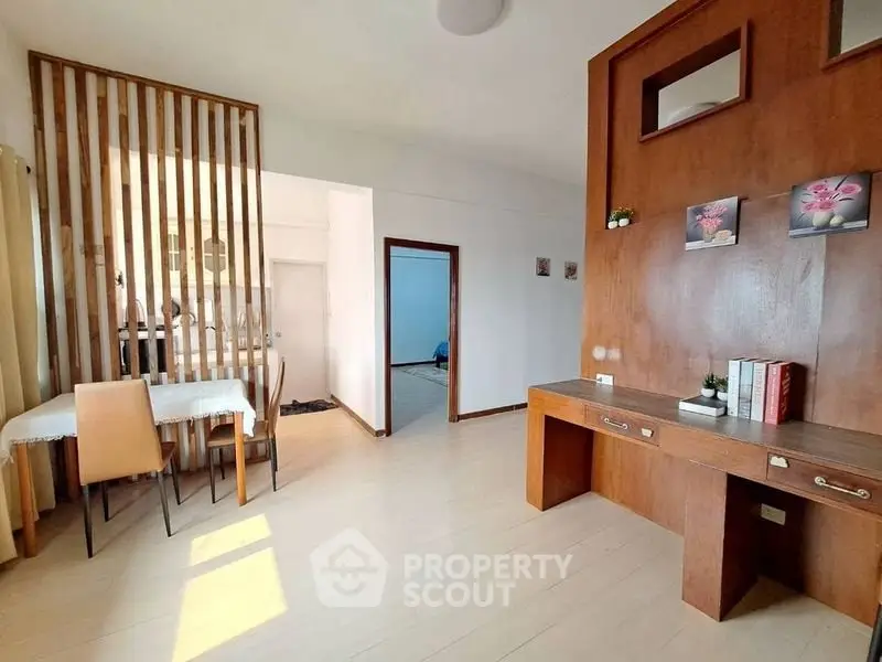 Spacious living area with modern wooden accents and natural light