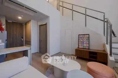 Modern living room with stylish furniture and staircase in a contemporary apartment.