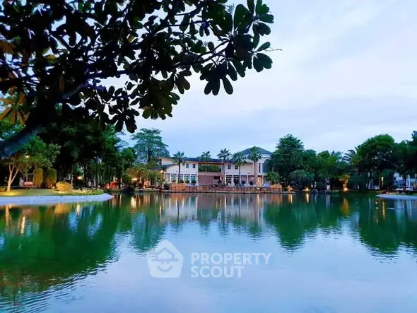 Stunning lakeside view of a luxurious property surrounded by lush greenery and serene waters.