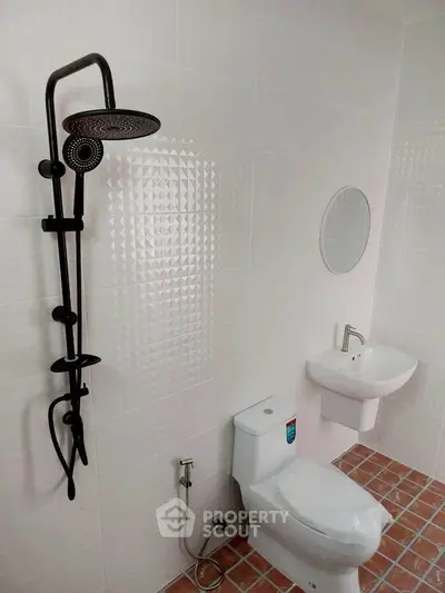 Modern bathroom with sleek showerhead and minimalist design