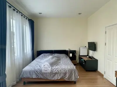 Spacious bedroom with modern furnishings and natural light