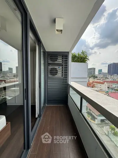 Modern balcony with city view and sleek glass railing in urban apartment