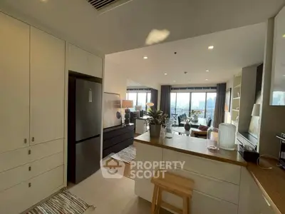 Modern open-plan kitchen and living room with city view and stylish decor