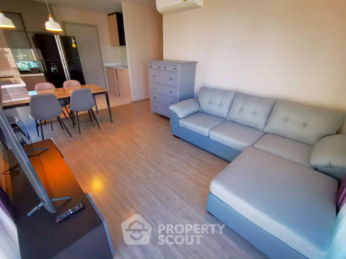 Modern living room with stylish furniture and open kitchen layout