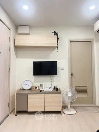 Modern living room with minimalist decor and wall-mounted TV