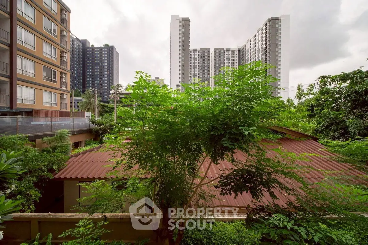 Urban residential view with lush greenery and modern high-rise buildings.