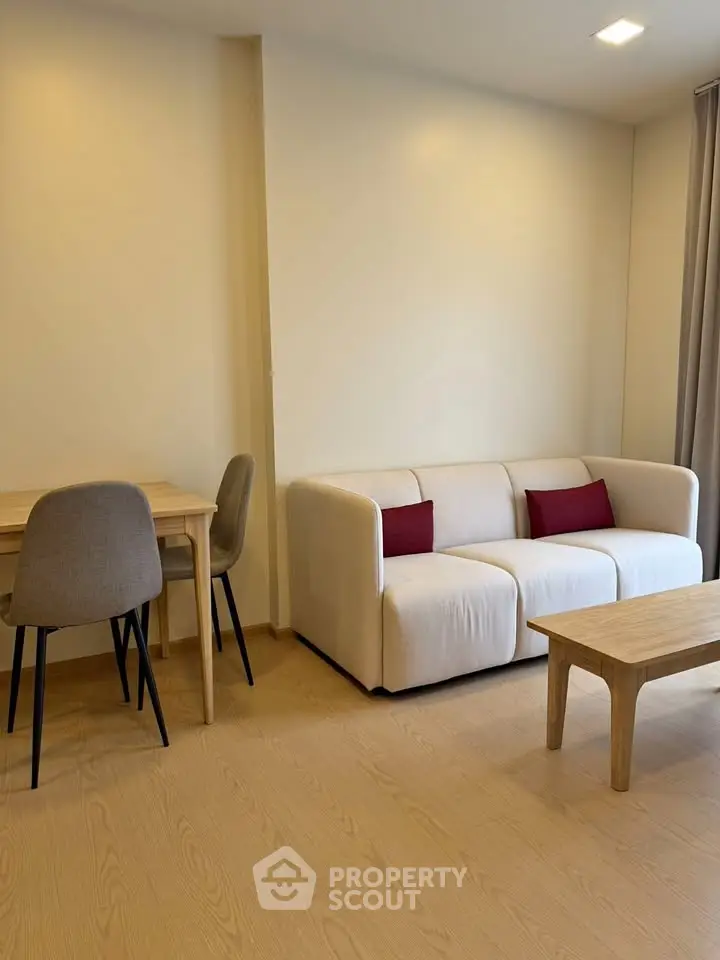 Modern living room with cozy sofa and dining area in a stylish apartment.