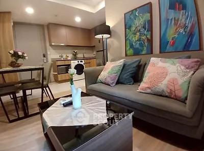 Modern living room with stylish decor and open kitchen layout in a cozy apartment.