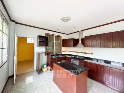 Spacious kitchen with modern cabinetry and island in a bright home