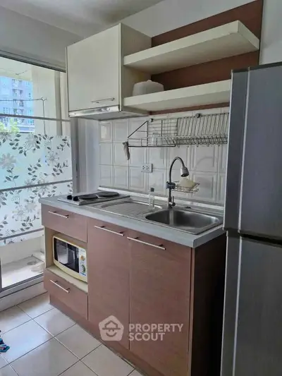 Modern kitchen with sleek cabinetry and stainless steel appliances in a compact layout.