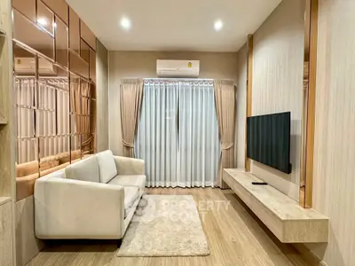 Modern living room with sleek design, featuring a cozy sofa, wall-mounted TV, and elegant curtains.