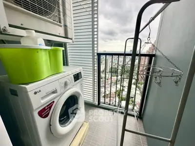 Compact balcony with washing machine and city view, perfect for urban living.