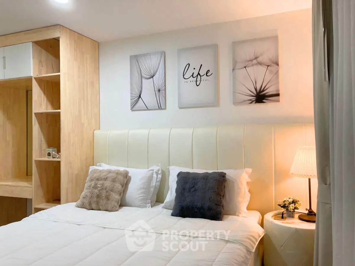 Cozy bedroom with elegant decor and soft lighting, featuring a comfortable bed and stylish wall art.