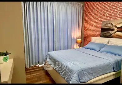 Cozy bedroom with modern decor and brick accent wall, featuring a comfortable bed and soft lighting.