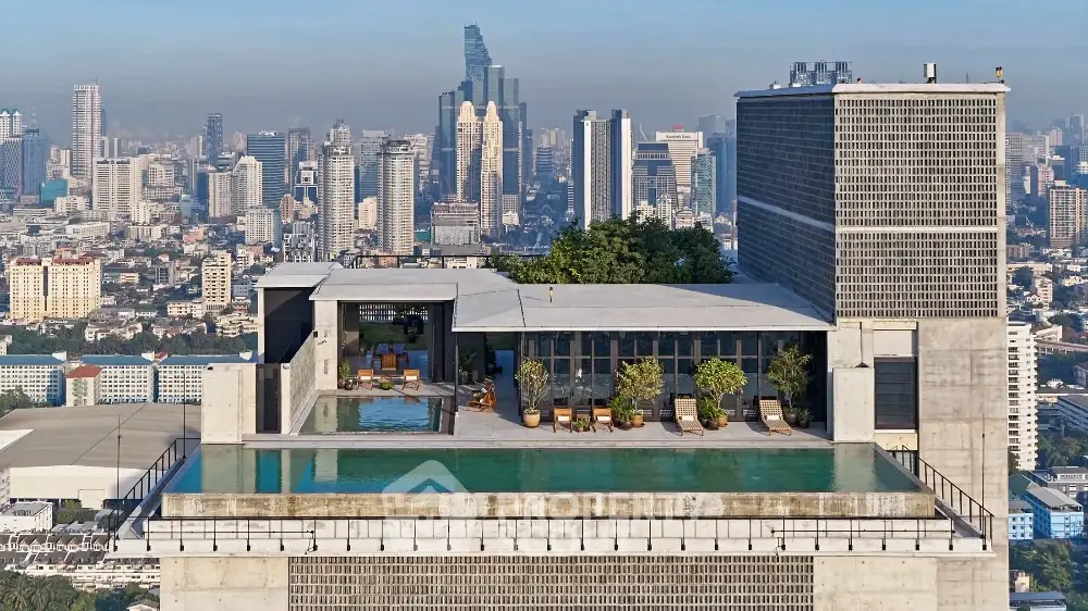 Stunning rooftop pool with panoramic city skyline views in luxury high-rise building.