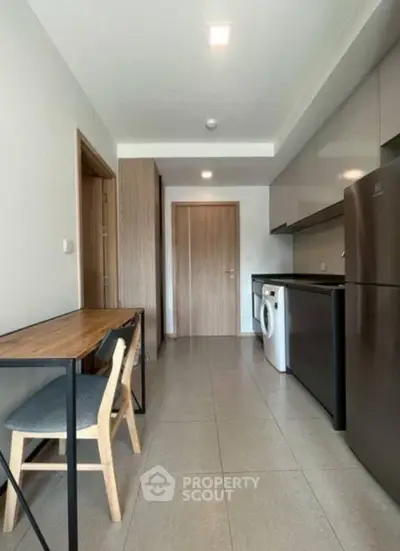 Modern kitchen with sleek appliances and wooden accents