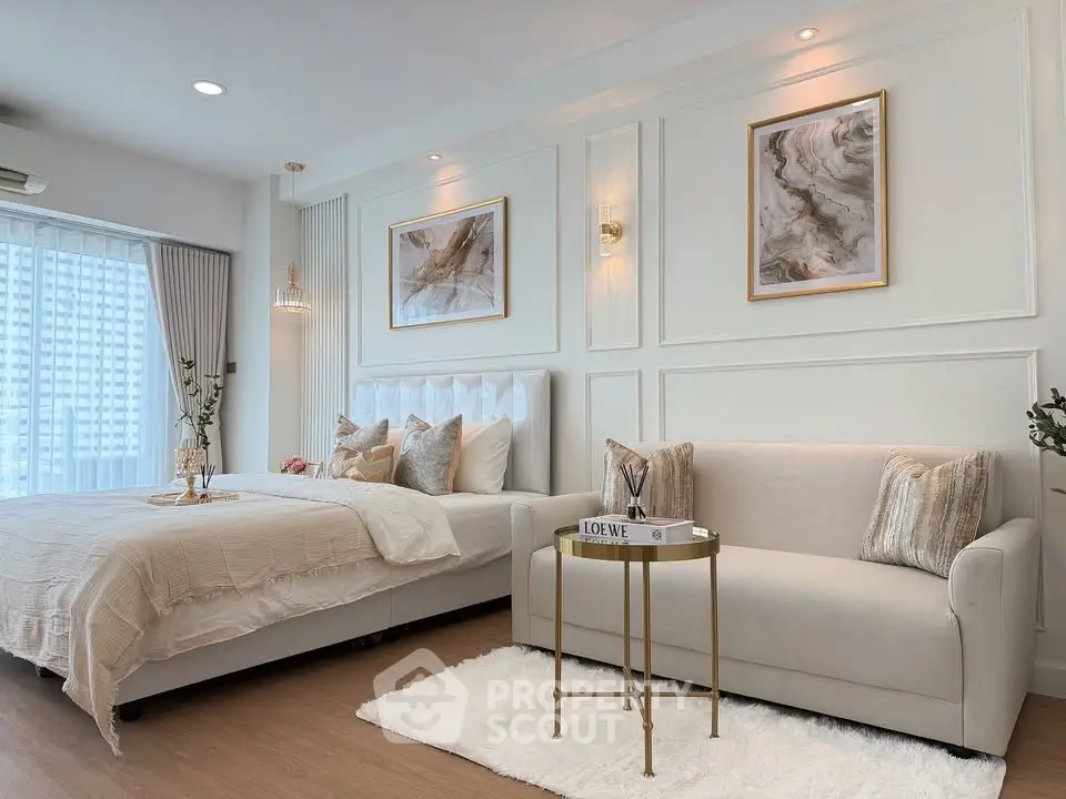 Luxurious bedroom with elegant decor and cozy seating area, perfect for relaxation and comfort.