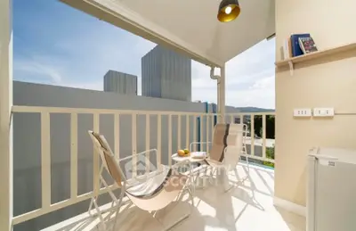 Charming balcony with modern chairs and scenic view, perfect for relaxation and enjoying the outdoors.