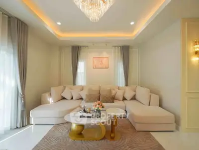 Luxurious living room with elegant chandelier and plush sectional sofa