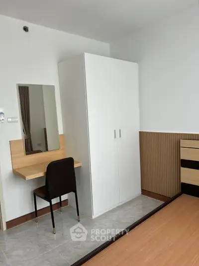 Modern bedroom with sleek wardrobe and stylish vanity desk, perfect for urban living.