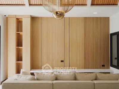 Modern living room with elegant wooden paneling and stylish lighting fixture