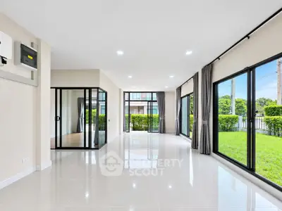 Spacious modern living room with large windows and garden view