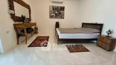 Spacious bedroom with elegant wooden furniture and stylish decor